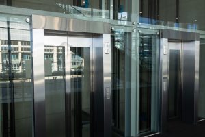 Side view of two modern elevators in a workplace